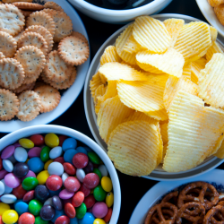 Bowls of candy, chips, pretzels and other snack foods.